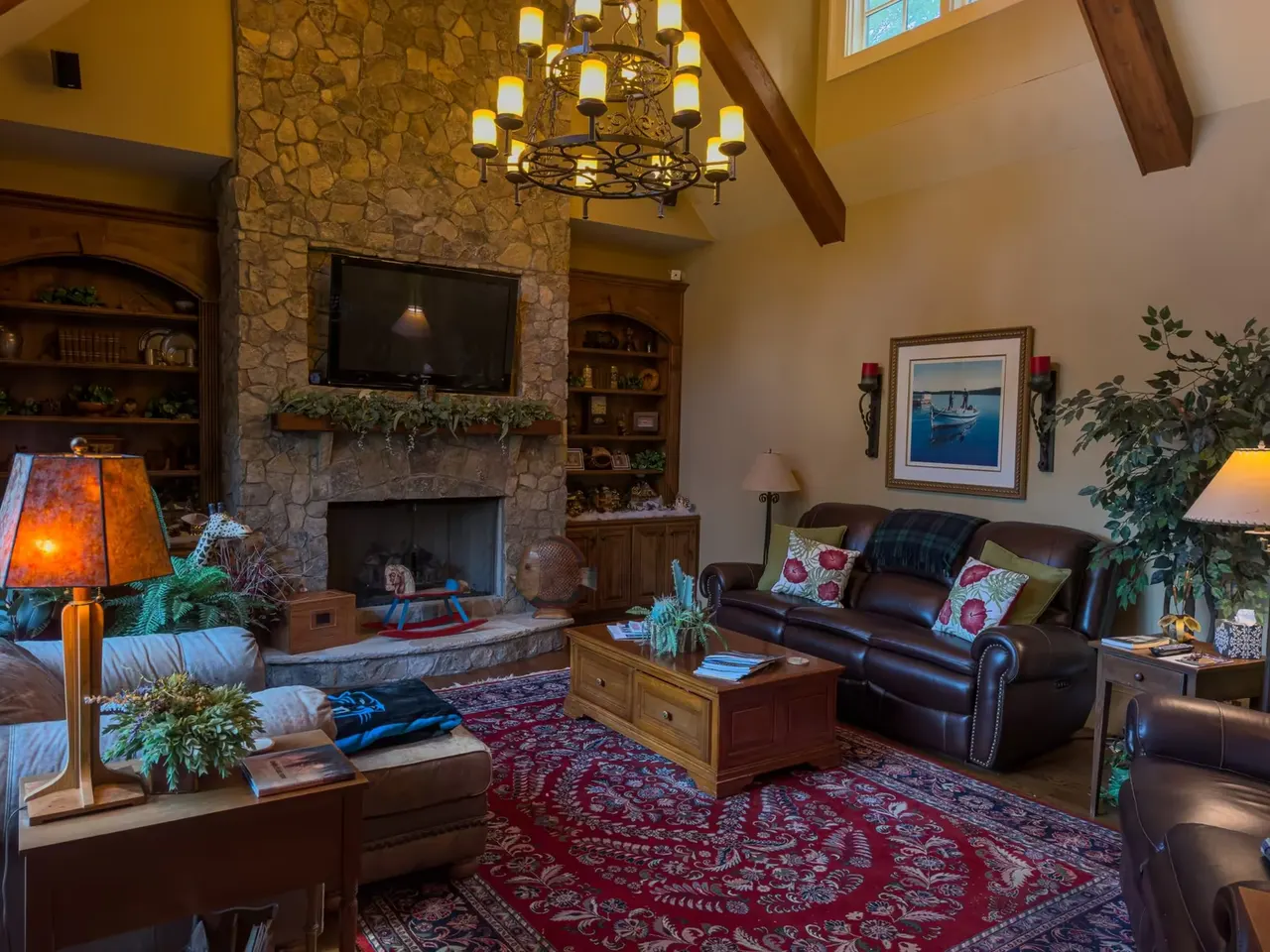 Living room with vaulted beamed ceiling and fieldstone fireplace