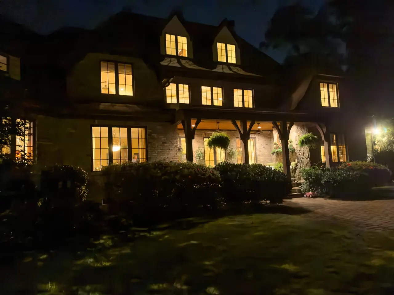 Rear elevation at night with the loggia lit