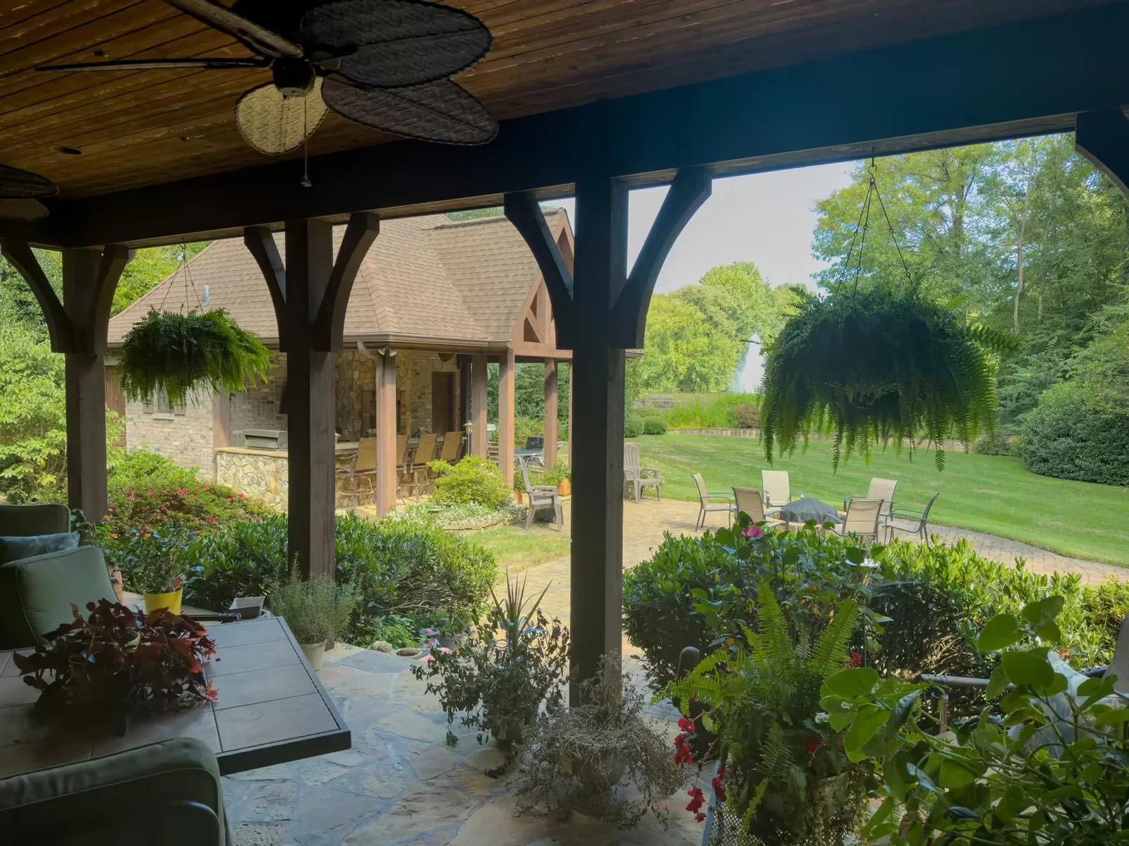 Original daylight photograph of a timber lanai looking toward a garden pavilion