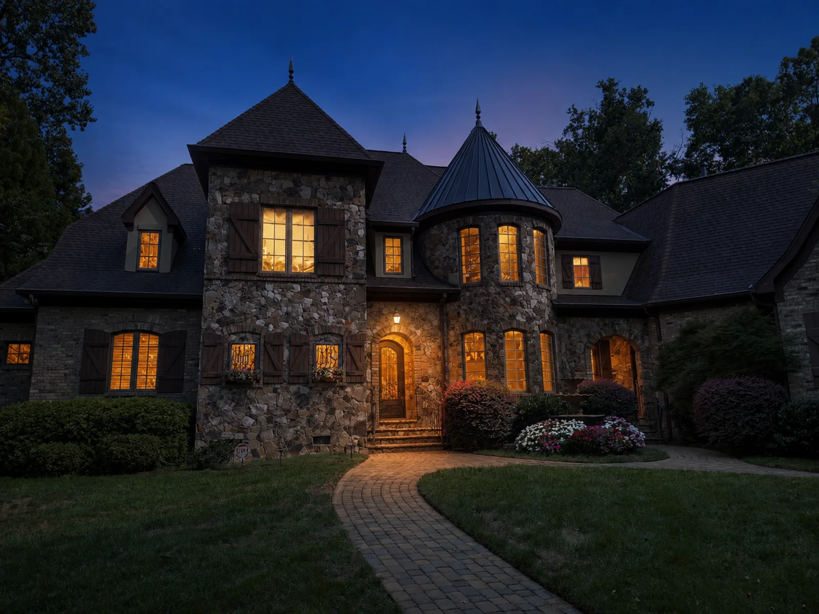 AI evening lighting interpretation of the same view of a stone home with a turret and curved front path