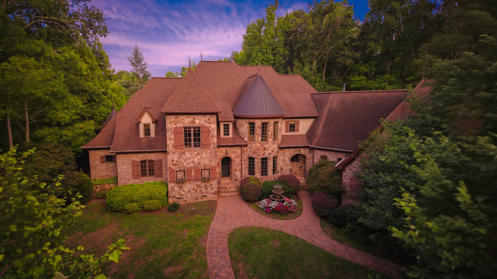 Owner-selected evening photograph of the turreted stone home and wooded grounds at Secretariat Lane