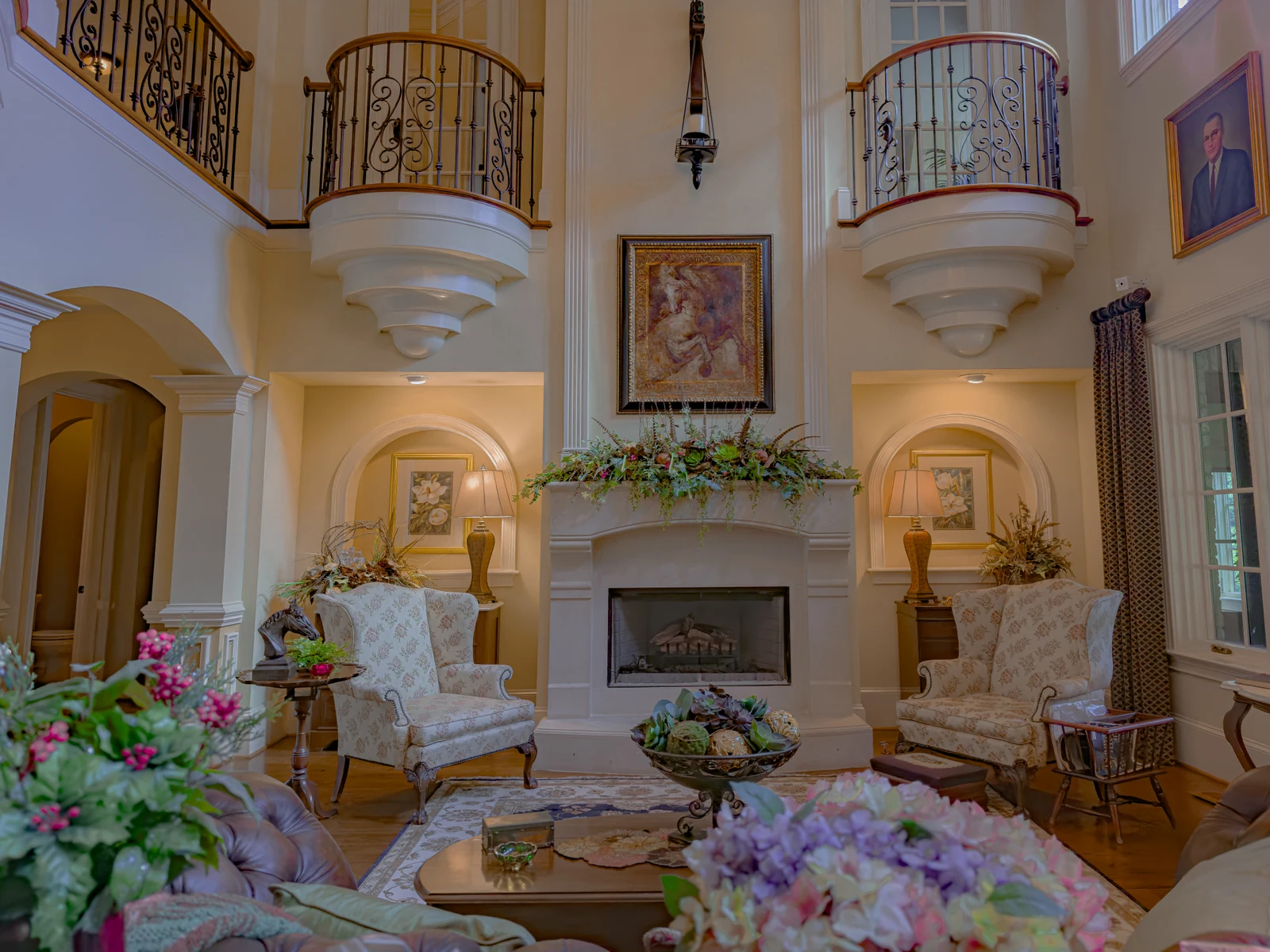 Double-height great room with fireplace and curved balconies at Secretariat Lane